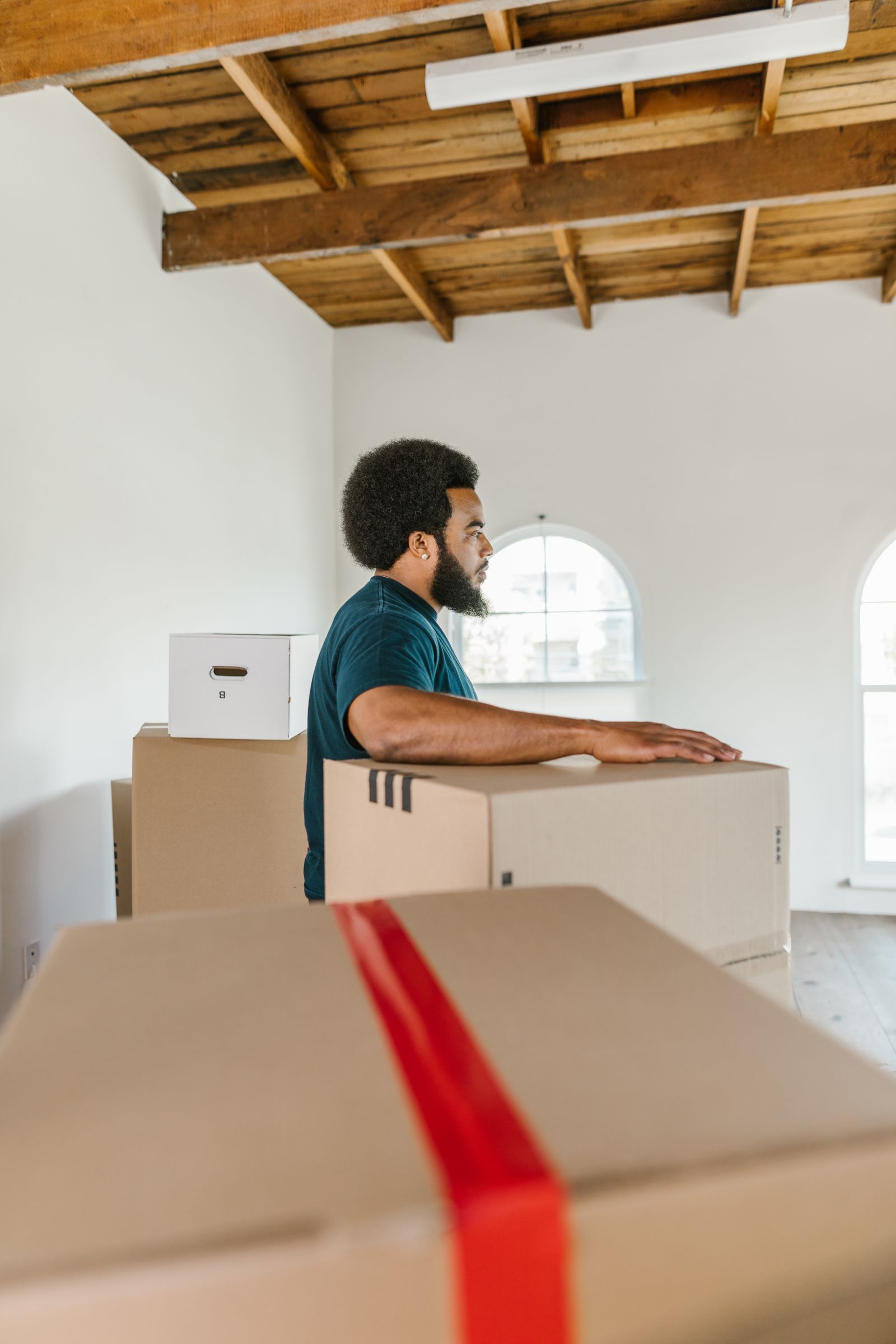 Removalist carrying a packed moving box